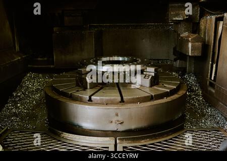 Industrial CNC Lathe Machine Cutting Metal Component in Manufacturing Facility Stock Photo