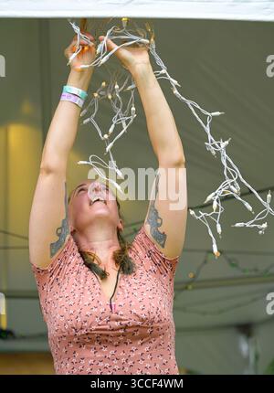 Woman putting up fairy lights Stock Photo