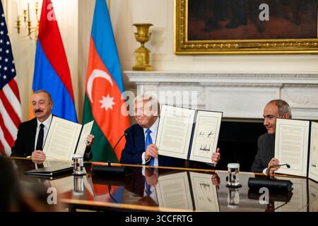 President Donald J. Trump, Azerbaijani President Ilham Aliyev, and Armenian Prime Minister Nikol Pashinyan display signed agreements during a historic peace summit at the White House on Friday, August 8, 2025. Image courtesy of the White House. Stock Photo