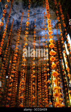 Mexico City, Mexico - November 3, 2024: Marigold garlands suspended from the ceiling at Anahuacalli Museum, Mexico City, creating a vibrant Day of the Stock Photo