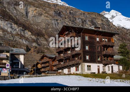 Traditional Swiss Chalets in Zermatt with Matterhorn summit with flags ...
