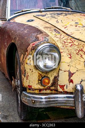 Close-Up of a Vintage Car with Rusted Body and Peeling Paint Stock Photo