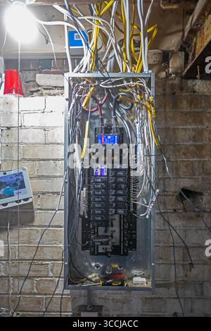 Detroit, Michigan - An electrical panel is wired as workers remodel a house in the Morningside neighborhood. The house had been vacant for many years. Stock Photo