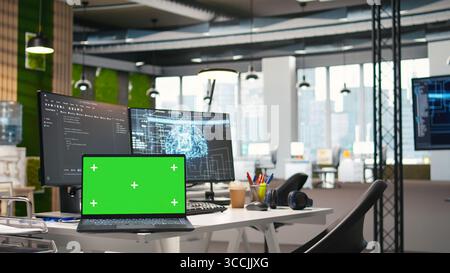 Isolated screen laptop in empty AI startup office displaying programming languages used for building applications. Chroma key notebook showing deep learning code in software development agency Stock Photo