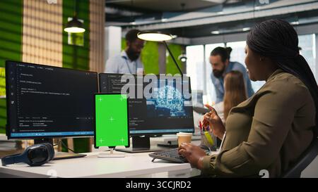 Admin writing code on isolated screen tablet, developing machine learning APIs. IT specialist using chroma key device to troubleshoot software errors using artificial intelligence, camera A Stock Photo