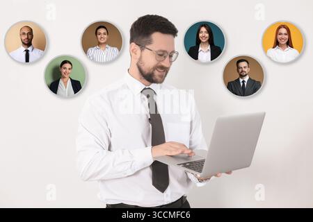 Recruiter with laptop looking for employee against white background. Photos of candidates near him. Human resources management Stock Photo