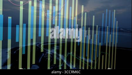Displaying transparent overlay with pale blue bar charts and pink line graphs on lakeshore at dawn Stock Photo
