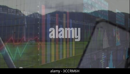 Displaying transparent digital dashboard covering field, with bar and line charts, numeric panels Stock Photo
