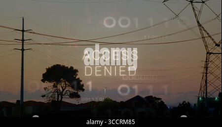 Displaying ACCESS DENIED overlay above suburban skyline at dusk, with utility poles and binary code Stock Photo