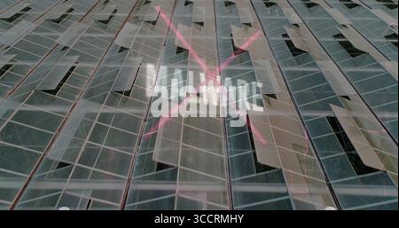 Highlighting neon pink X-shaped lights intersecting UNMARE text on glass wall, with metal framing Stock Photo