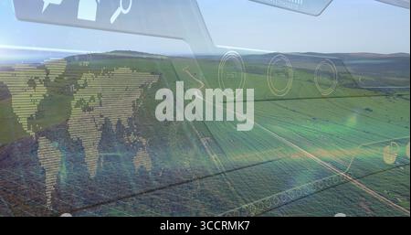 Displaying rolling green fields and winding dirt tracks on hillside farmland, with digital overlays Stock Photo