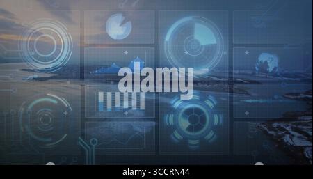Displaying holographic overlay over dusk shore, showing radar, line, bar and pie charts, globe icon Stock Photo