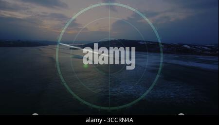 Displaying semi-transparent digital radar overlay graphic scanning aerial sea at dusk, with waves Stock Photo