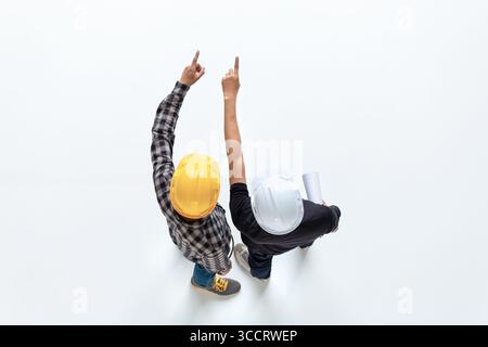 Aerial view of engineers discussion with architects and checking plan at construction site. Building development concept with copy space. Stock Photo