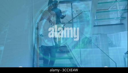 Descending trio business professionals using glass office stairs, displaying digital data overlay Stock Photo