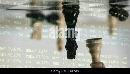 Displaying wooden queen chess piece alongside pawn on studio chessboard with stock ticker overlays Stock Photo
