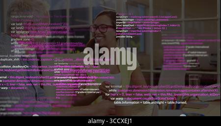 Pointing senior mentor guiding smiling developer at laptop in modern office, with coding overlay Stock Photo