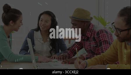 Collaborating students discussing project in study room, with laptop, printed documents and pencils Stock Photo