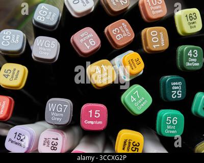 Collection of markers with different colors and numbers on them. The markers are arranged in a row, with some of them being green, yellow, and brown. Stock Photo