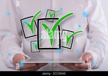 Validation concept above a tablet held by a man in background Stock Photo