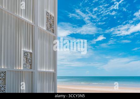 Modern decorative white wall by tropical beach and cloud in blue sky on summer Stock Photo