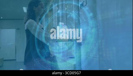 Scanning ID card, woman in black top using access reader in hallway with lockers, copy space Stock Photo