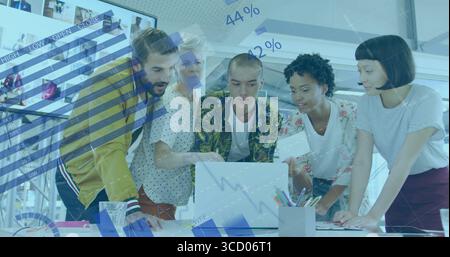 Collaborating five coworkers analyzing data on laptop in studio, with colored pencils and reports Stock Photo