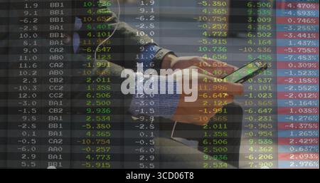 Man in coat sweater browsing stocks on phone on grey lounge bench with headphones earbuds overlay Stock Photo