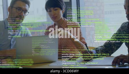 Collaborating tech professionals analyzing code at conference table, with laptop and coffee mug Stock Photo