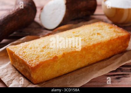 Traditional homemade cassava cake whit coconut on a rustic wooden table. Front view Stock Photo
