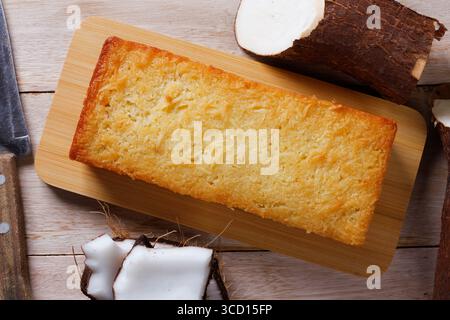 Traditional homemade cassava cake whit coconut on a rustic wooden table. Top view Stock Photo
