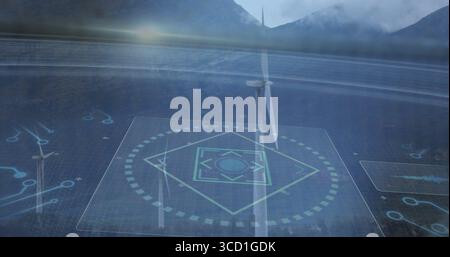 Displaying wind turbine rotating in foggy valley with holographic grid overlay and floating panels Stock Photo