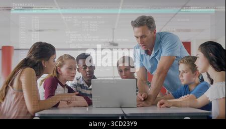 Guiding male instructor leaning over table instructing students at lab, with laptop code overlay Stock Photo