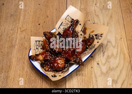 Sheffield, UK 17 March 2020: Korean Wings – chicken wings in a spicy bbq chilli sauce from Unit Sheffield Stock Photo