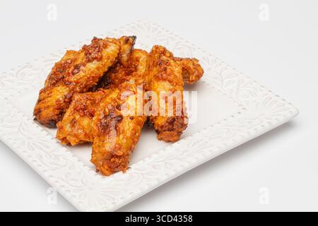 Spicy Buffalo and Garlic Wings on a White Plate Stock Photo
