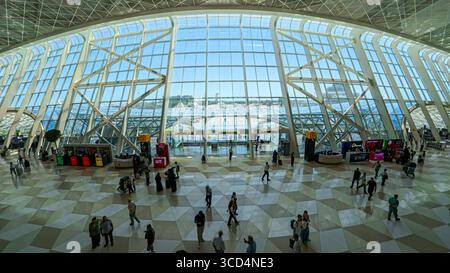 Baku, Azerbaijan - 27 July 2025: Modern terminal interior of Heydar Aliyev International Airport in Baku with curved glass architecture, passengers an Stock Photo