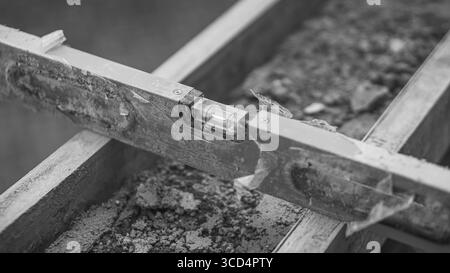 A spirit level rests on concrete to ensure surface evenness, an essential step in maintaining precision and quality in construction work Stock Photo