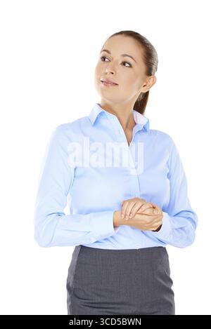 Beautiful young woman thinking standing with her hands clasped in front of her looking up into the air isolated on white Stock Photo