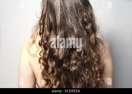 Back side view rear of young female curly hair Stock Photo