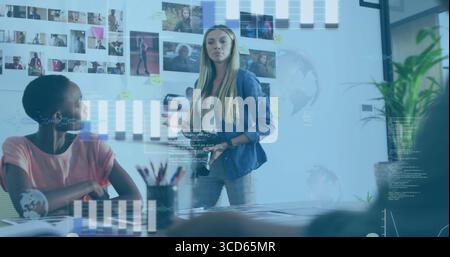 Presenting coworker wearing denim leading meeting in boardroom with printed photos and sticky notes Stock Photo