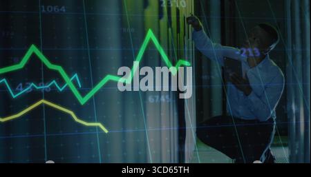 Kneeling IT tech examining rack in server room aisle, holding tablet with data overlay, copy space Stock Photo
