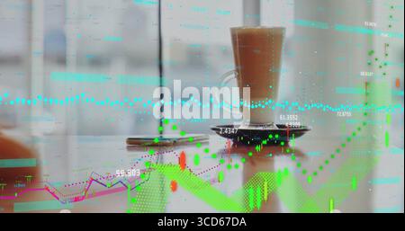 Glass mug of latte sitting on saucer on table by window, with smartphone and chart overlays Stock Photo