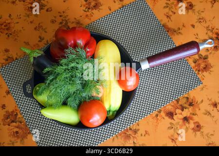 Set of different fresh vegetables in frying pan. Proper nutrition. Dietary menu. Top view. Stock Photo