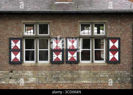 Red brick wall with two windows Stock Photo