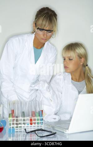 Female lab workers testing and experimenting Stock Photo