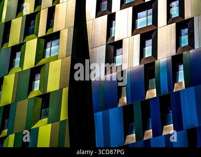 Colorful modern building facade with geometric patterns and windows. Stock Photo