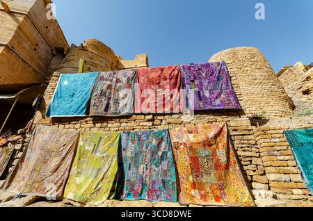 Colorful patchwork textiles or embroidered fabrics for sale in Jaisalmer fort, Rajasthan, India Stock Photo