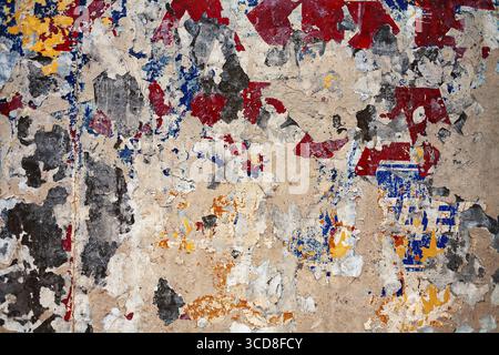 Bumpy plastered wall covered with mess of color spots and scratches Stock Photo
