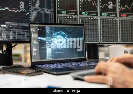 Close up of day trader using AI tech on laptop capitalize on market fluctuations when buying and selling stocks. Prop firm office worker uses artificial intelligence to identify profit opportunities Stock Photo