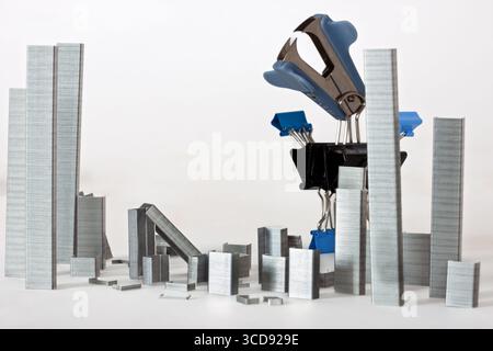 Conceptual monster done from paperclips and staples, staple city, with staple remover ogre monster, isolated on white background Stock Photo